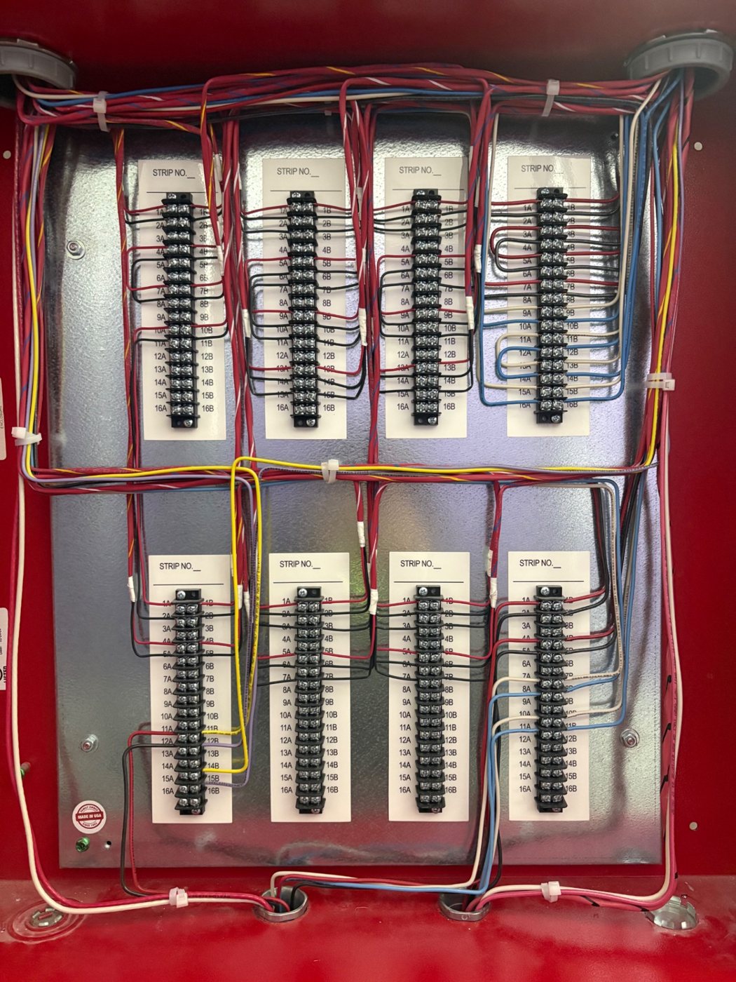 Neatly dressed and labeled terminal strips inside a fire alarm terminal cabinet